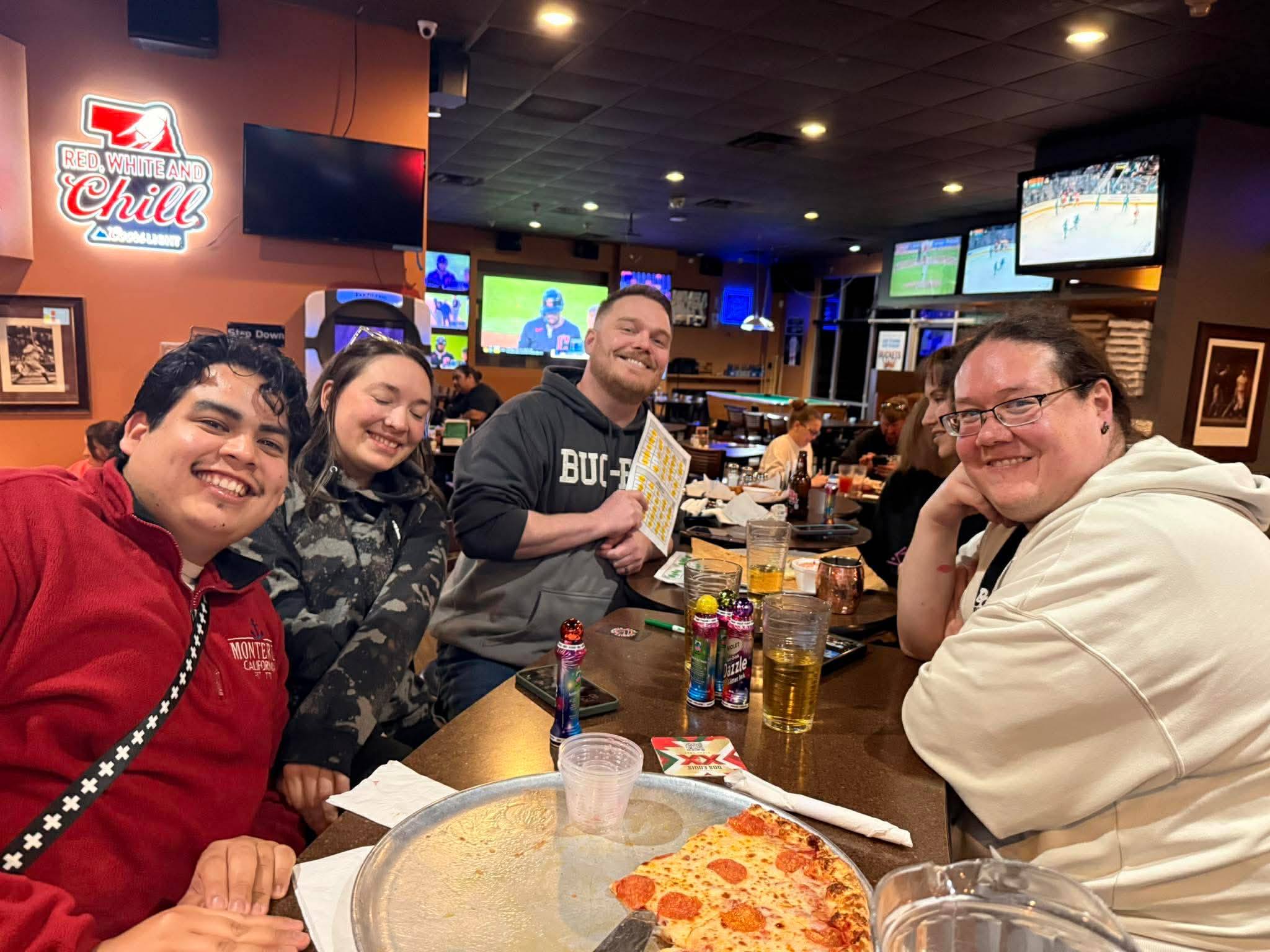 Paper Music Bingo cards, daubers, and drinks on a busy bar table
